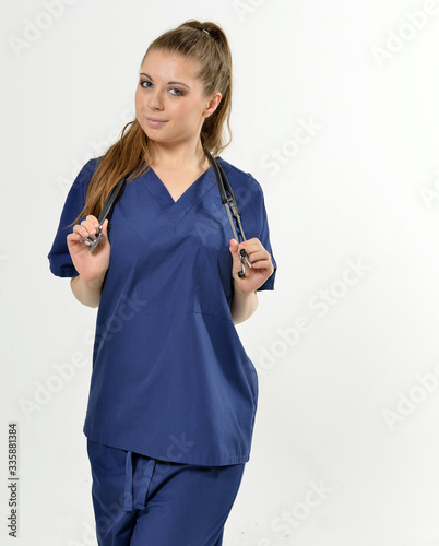 Beautiful young female medical professional with stethoscope - studio - no PPE present photo