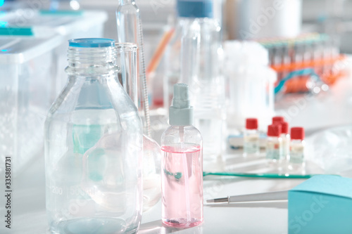 Scientific background with liquid samples in various glass and plastic tubes. RPR and RT-PCR test kits, reagents to analyze and amplify DNA in laboratory.