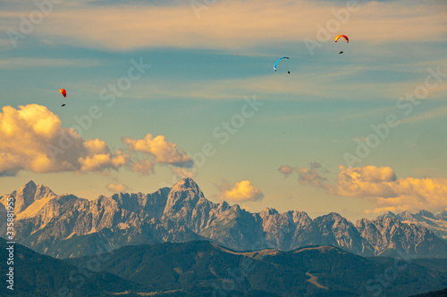 Panorama of the Austrian Alps Europe at Lake Ossiacher See with the mountains of the Karawanken Mountains with paragliders