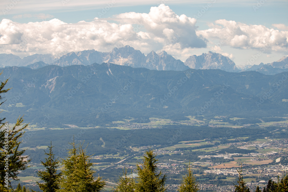 Panorama of the Austrian Alps,Europe,at Lake Ossiacher See with the mountains of the Karawanken Mountains with paragliders
