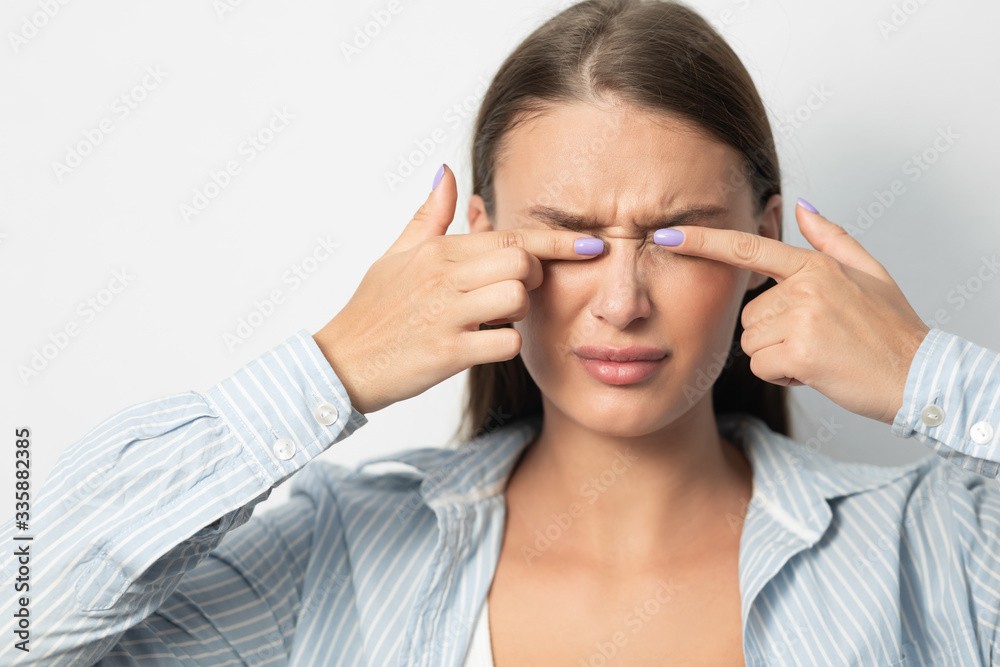 Woman Touching Eyes Standing Over White Background, Studio Woman Touching Eyes Standing Over White Background, Studio