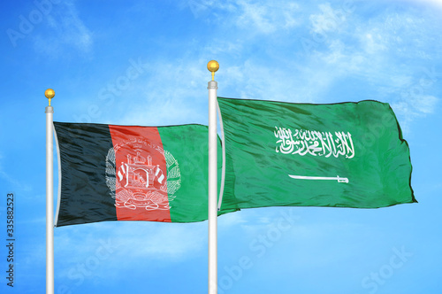 Afghanistan and Saudi Arabia two flags on flagpoles and blue cloudy sky