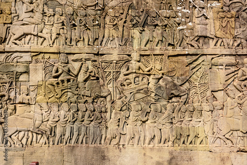 Picturial stories carved into the wall at the Unesco World Heritage site of Ankor Thom, Siem Reap, Cambodia