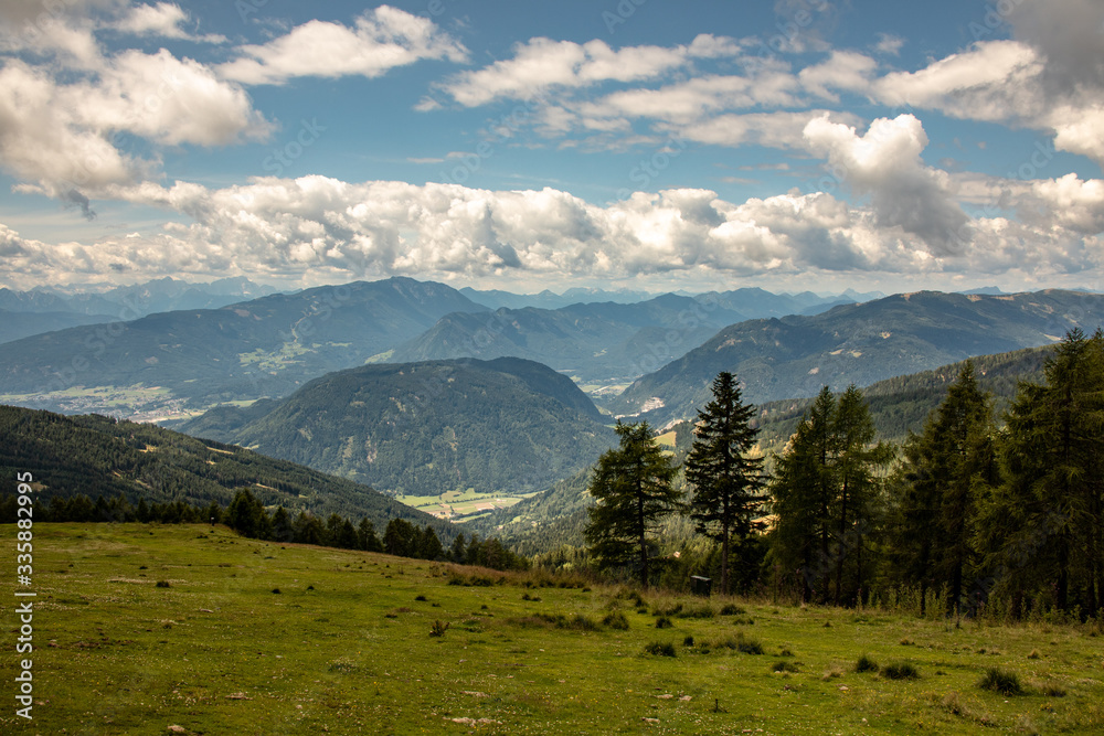 Panorama of the Austrian Alps,Europe,at Lake Ossiacher See with the mountains of the Karawanken Mountains with paragliders