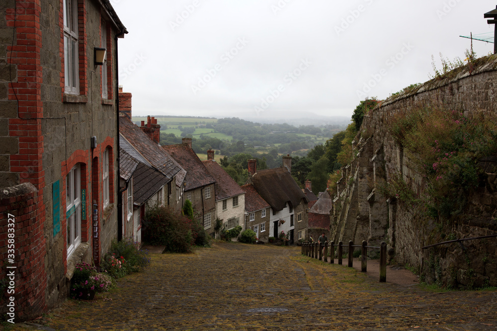 Shaftsbury (England), UK - August 07, 2015: The Gold Hill road and houses in Shaftsbury, England, United Kingdom.