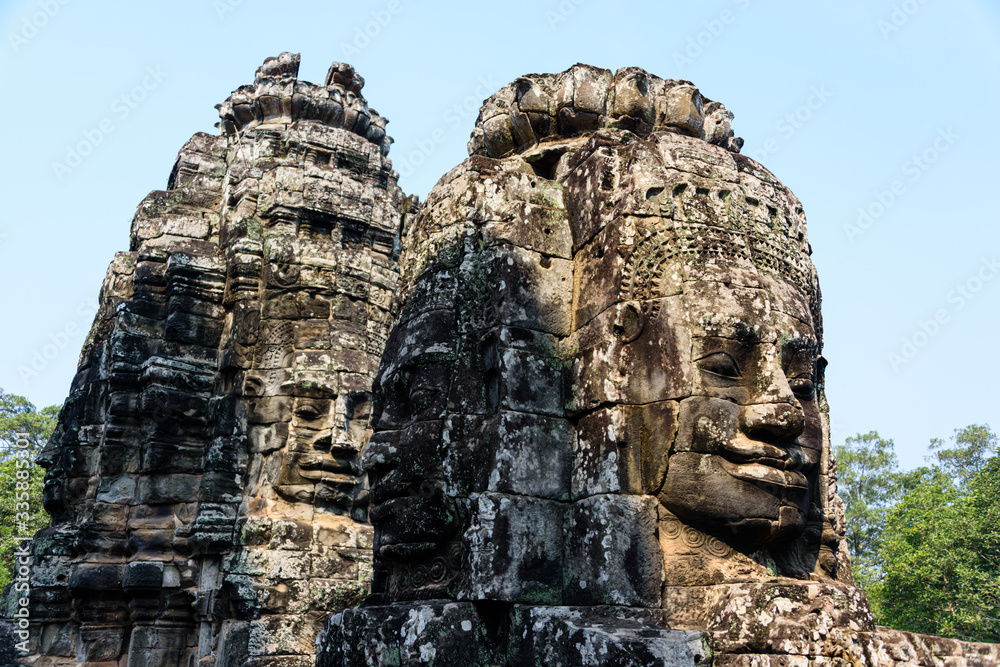 Multiple large faces of the Buddha are carved in to the side of the Unesco World Heritage site of Ankor Thom, Siem Reap, Cambodia