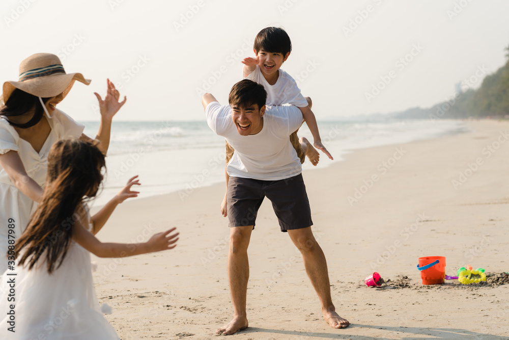 © tirachard - Asian young happy family enjoy vacation on beach in the evening. Dad, mom and kid relax playing together near sea when sunset while travel holiday. Lifestyle travel holiday vacation summer concept. © tirachard - Asian young happy family enjoy vacation on beach in the evening. Dad, mom and kid relax playing together near sea when sunset while travel holiday. Lifestyle travel holiday vacation summer concept.