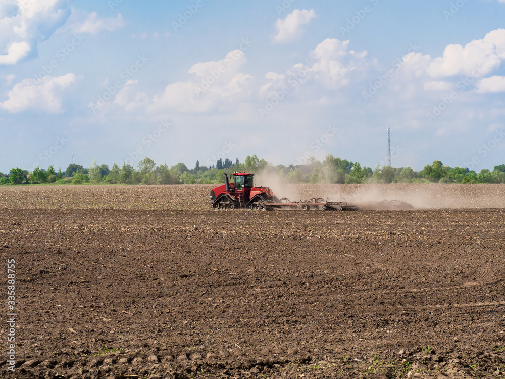 Farmer cultivating arable land before seeding Farmer cultivating arable land before seeding