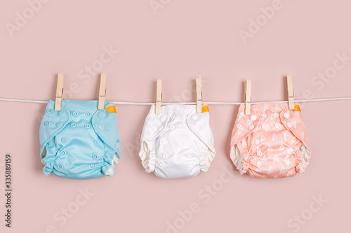 Reusable cloth baby diapers drying on a clothes  line Poster Mural XXL