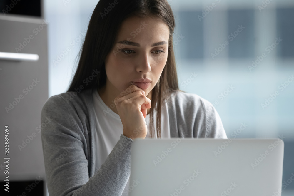 Pensive millennial woman look at laptop screen working thinking about problem solution, thoughtful young businesswoman busy consulting client online browsing web on modern computer Pensive millennial woman look at laptop screen working thinking about problem solution, thoughtful young businesswoman busy consulting client online browsing web on modern computer