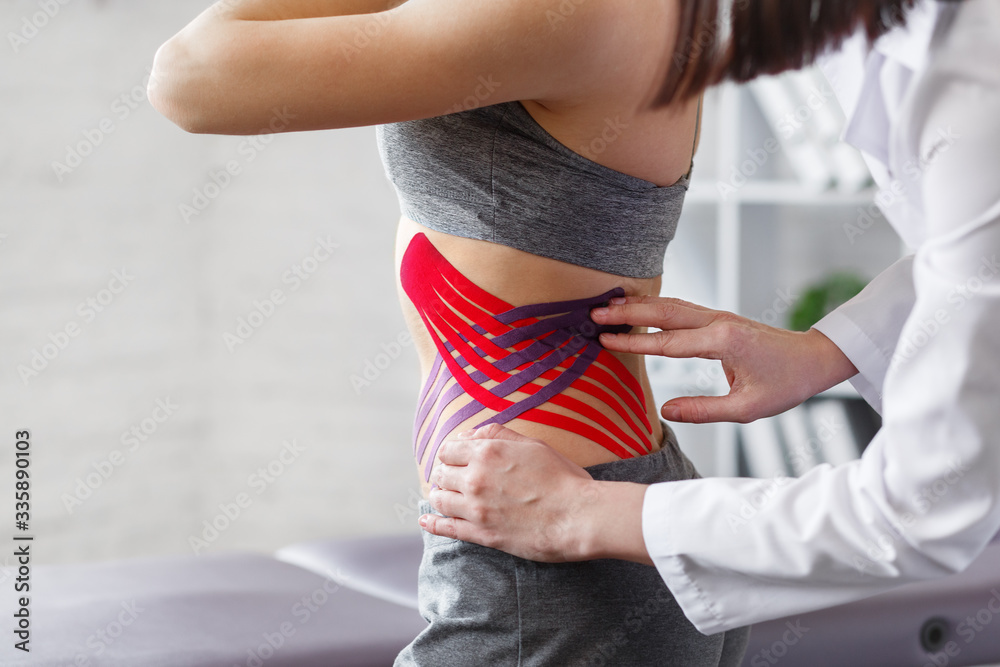Weight loss concept.Kinesiology taping.Therapist applying kinesiology tape  to patient belly.Anti-cellulite procedure for slim tummy.Fat lose,cellulite  removal, sport physical therapy,recovery concept. Stock Photo | Adobe Stock