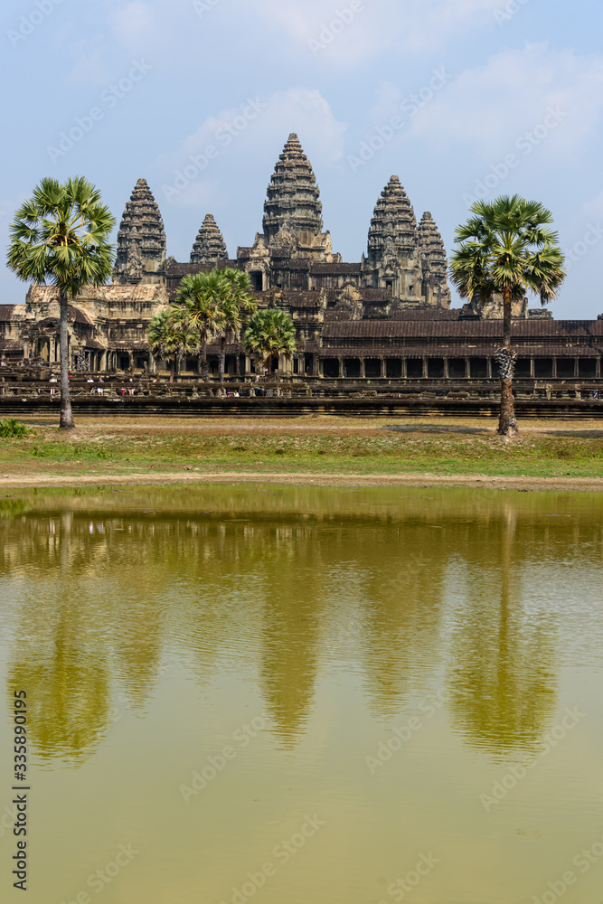 Distinctive stupa towers on the roof of the UNESCO World Heritage Site of Angkor Wat are reflected in a man-made lake, Siem Reap, Cambodia