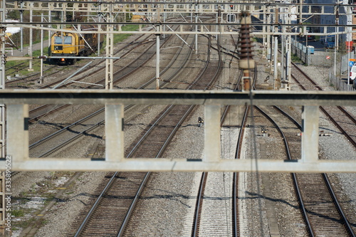 Multiple track railway, in perspective, train station in Schlieren, Switzerland. Downward view from a bridge over the rails. Some rails meet in the distance.