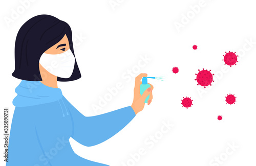COVID-19. Quarantine. A girl in a protective face mask sprays a disinfectant spray on the spores of a coronavirus