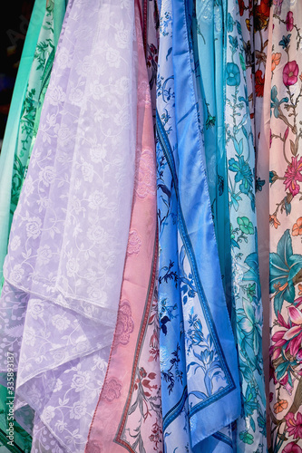 Russian traditional decorative shawls in the store close-up. © Artemy Sobov