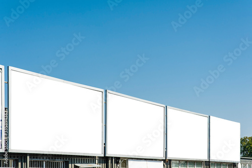 Blank white advertising billboards in the front of the building