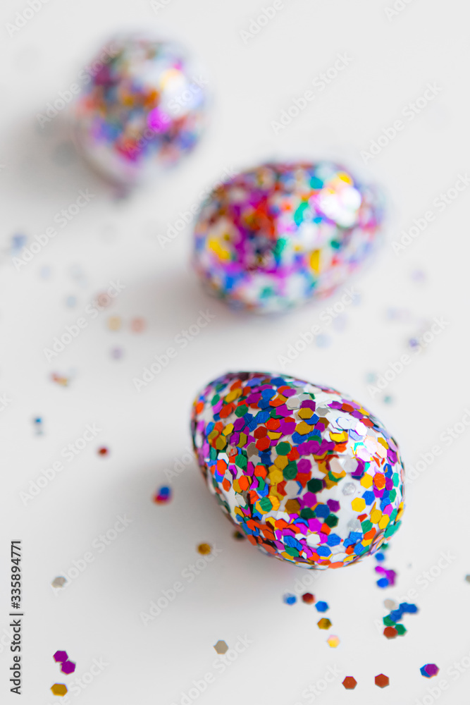 Glitter easter eggs on white background