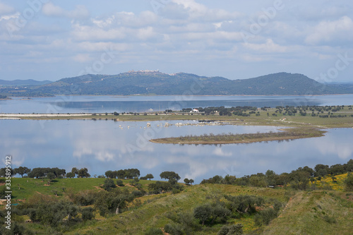 Lake reservoir water reflection of Alqueva Dam landscape and Monsaraz on the foreground in Alentejo  Portugal