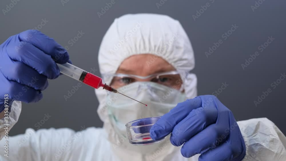 Laboratory assistant hold syringe with blood. Close up. Laboratory assistant hold syringe with blood. Close up.