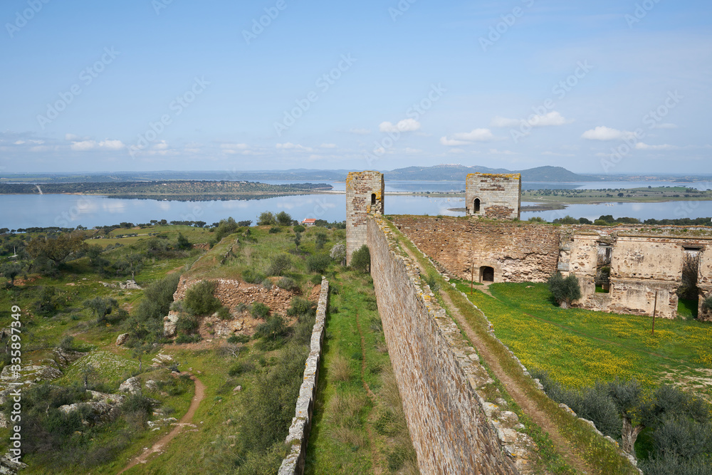 Mourao castle towers and wall historic building with alqueva dam reservoir in Alentejo, Portugal