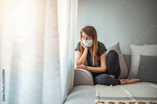 Woman in isolation at home for virus outbreak. Young woman in isolation at home for coronavirus. Woman in Isolation Quarantine Coronavirus. Sad lonely girl isolated stay at home