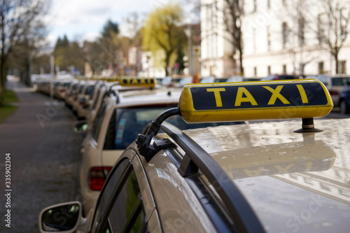 Canvas Print Berlin Germany, Line of yellow taxi cabs parking in a street in inner city of berlin