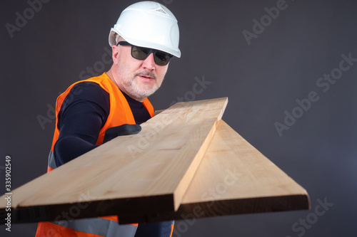 A man demonstrates lumber. ...