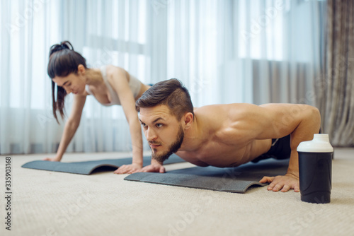 Morning fitness training of family couple at home