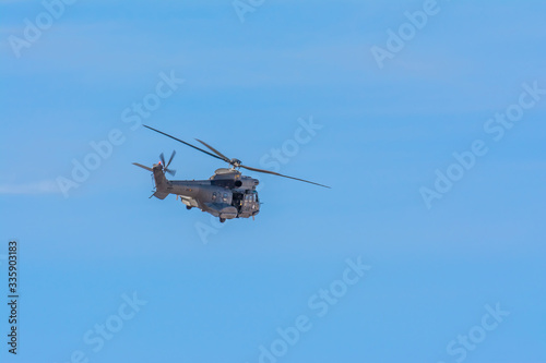 Fototapeta Naklejka Na Ścianę i Meble -  Spanish Army Hellicopter patroling during COVID-19 Lockdown, Las Palmas de Gran Canaria, Spain