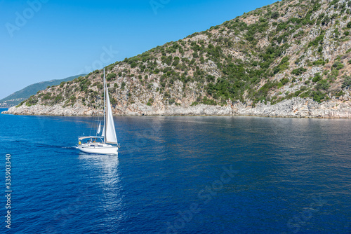 Sailing on the Ionian sea on the coastline of Lefkada island in a sunny day, Greece