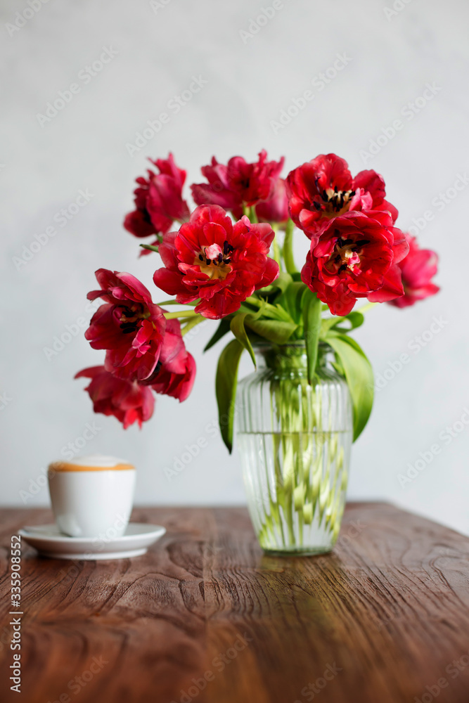 Beautiful tulips bouquet on wooden table