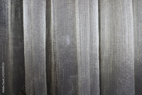 a beautiful fold of curtains in a light shade can be used as a texture and background