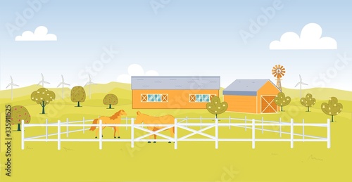 Wooden Corral on Field next to Stall and Windmill.