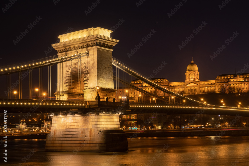 The Szechenyi Chain Bridge (Budapest, Hungary) with Buda Castle on the background at winter night