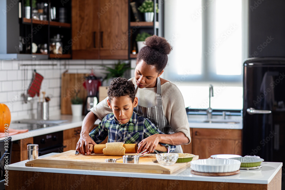 Mother with his son prepare pie in the kitchen Mother with his son prepare pie in the kitchen