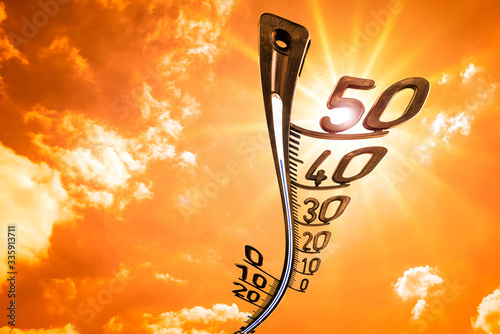 Sky with clouds, sun and thermometer - background for hot summer or heat wave