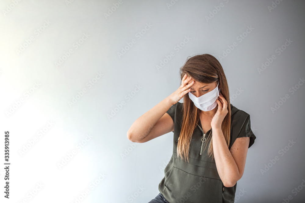 Beautiful caucasian infected girl on grey background in medical mask with inscription 2019-nCov. Coronavirus covid-19 concept. Pandemic global spread Beautiful caucasian infected girl on grey background in medical mask with inscription 2019-nCov. Coronavirus covid-19 concept. Pandemic global spread