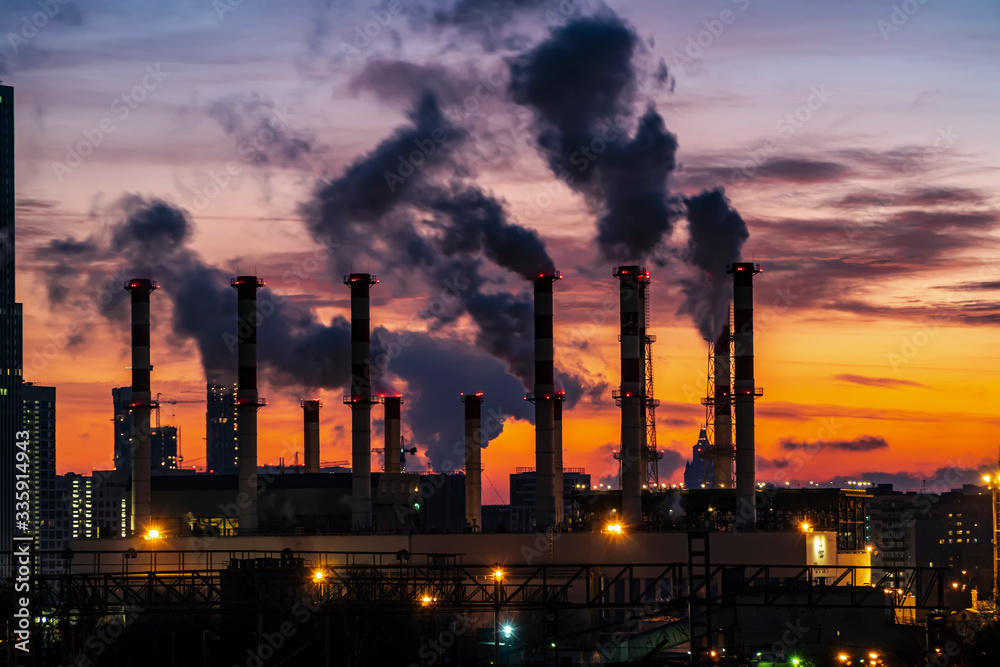industrial landscape, the pipes of the thermal power plant at sunset