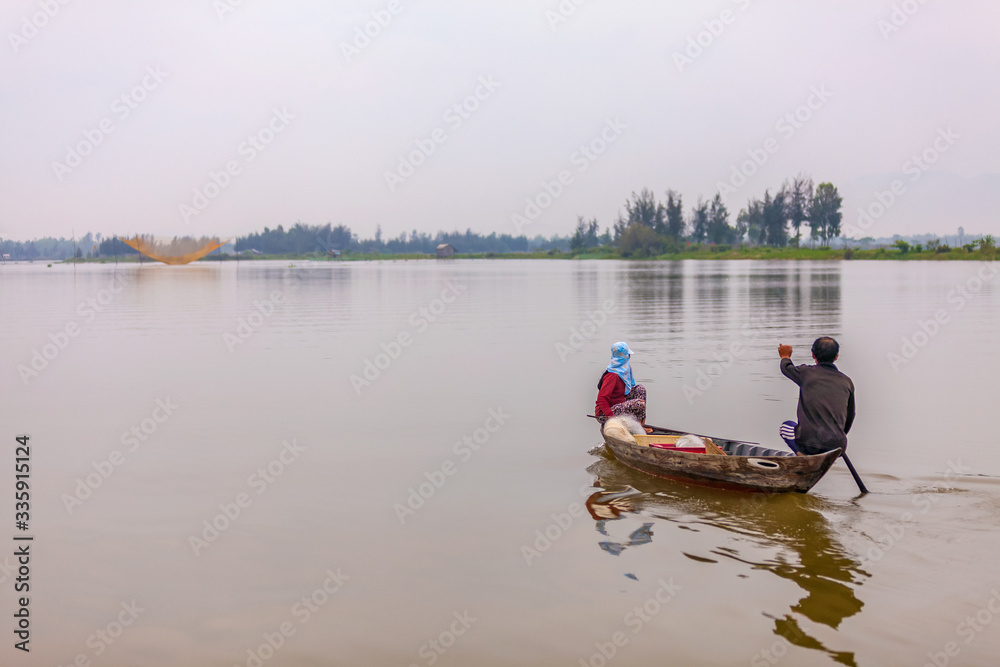 Fishing by Sampan at dawn on the Thu Bon river, Hoi An, Vietnam