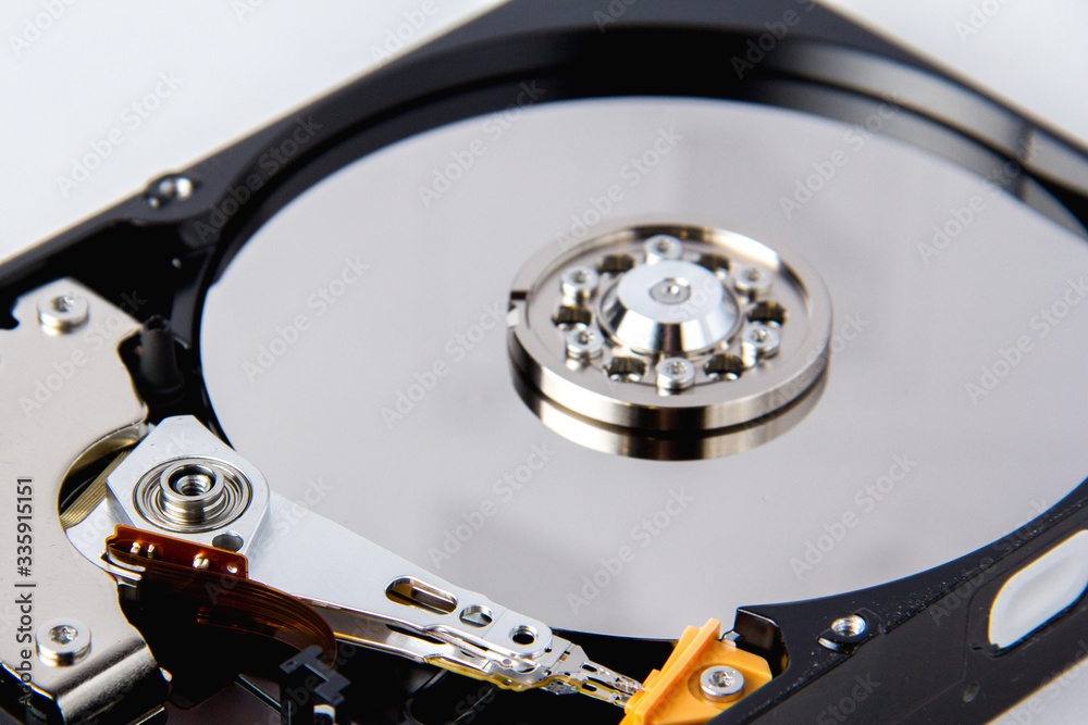 Opened computer hard drive on a white background. Opened computer hard drive on a white background.