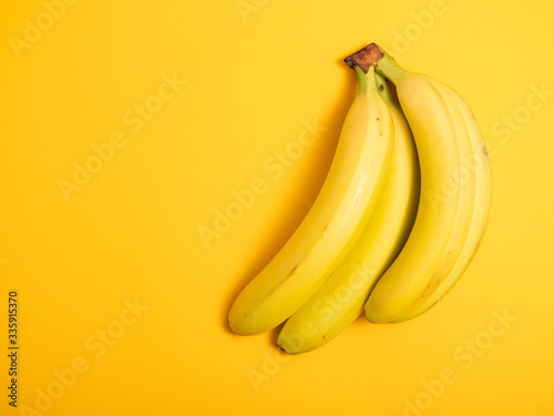 ripe bananas are isolated on a yellow background. the concept of healthy food