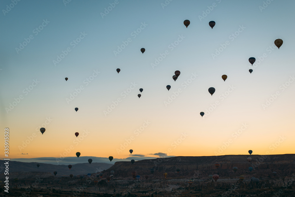 sunrise with hot air baloons in the air