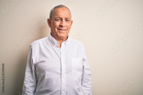 Senior handsome businessman wearing elegant shirt standing over isolated pink background with a happy and cool smile on face. Lucky person.