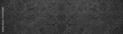 Old black anthracite vintage shabby patchwork hexagon print motif tiles stone concrete cement wall texture background