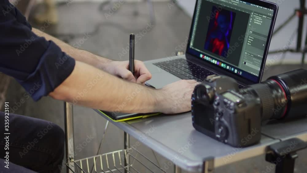 Hands of a male photographer, designer use a graphics tablet. Close up, slider shot.
