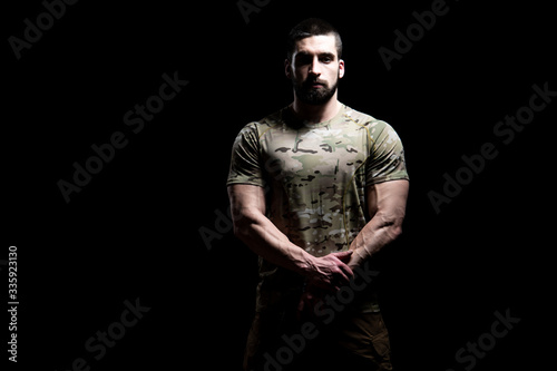 Military Man Holding Gun Isolated on Black Background