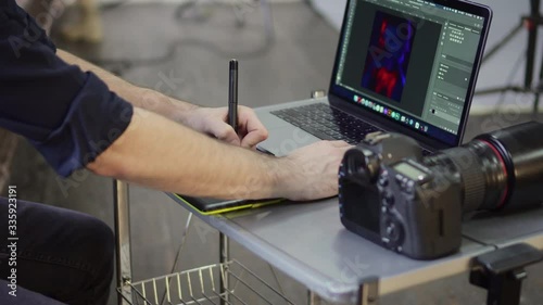 Hands of a male photographer, designer use a graphics tablet. Close up, slider shot. photo