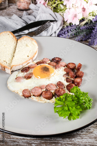 Fried egg with chopped sausage.