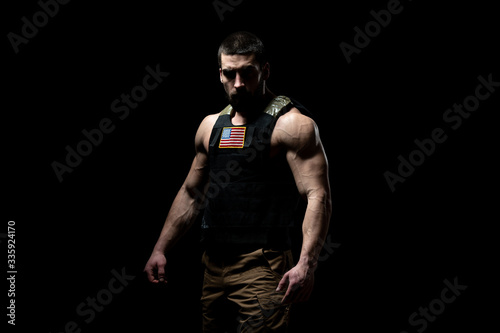 Bodybuilder Soldier With Bulletproof Vest on Black Background © Jale Ibrak