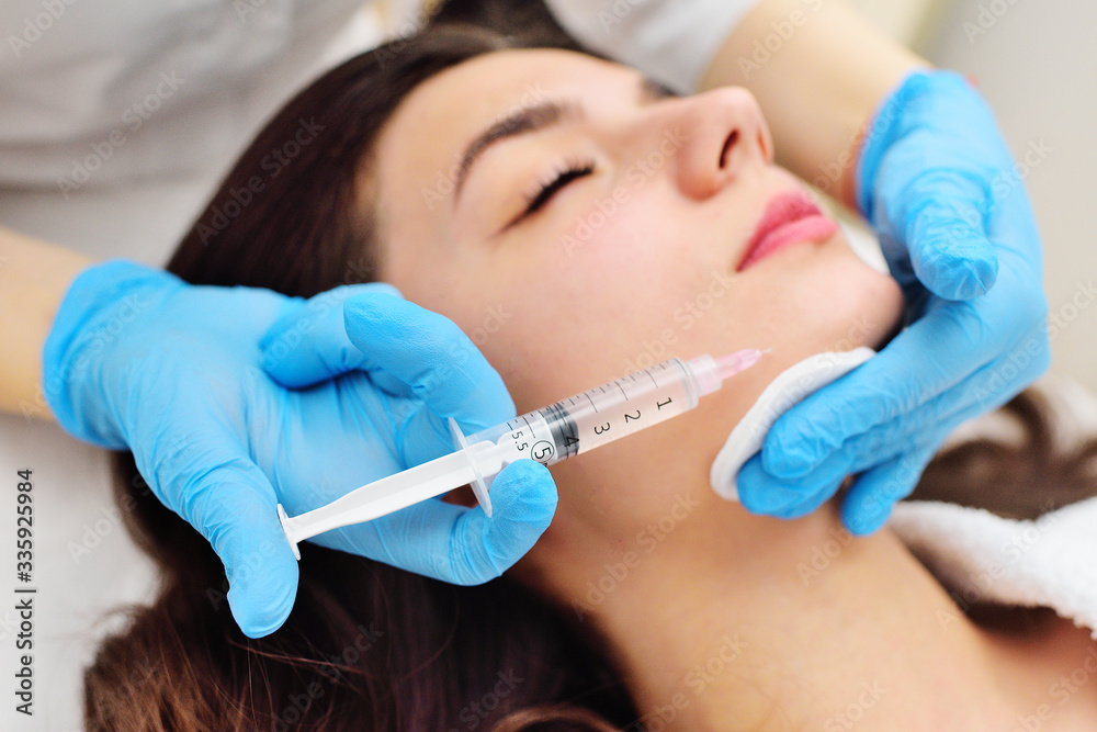 a cosmetic surgeon performs a facial skin rejuvenation procedure using an innovative technology in which plasma enriched with platelets is injected into the patient. a cosmetic surgeon performs a facial skin rejuvenation procedure using an innovative technology in which plasma enriched with platelets is injected into the patient.
